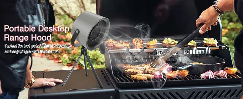Portable desktop range hood being used to cook food on a grill outdoors.