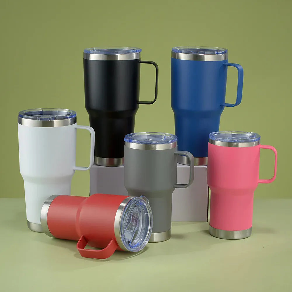 Set of colorful insulated travel mugs on a green background