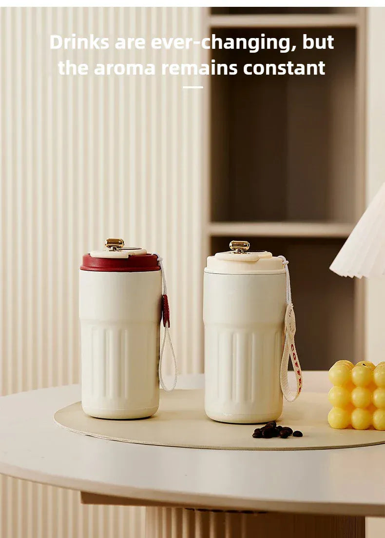 Two white ceramic tumblers on a table with text about drink aromas.