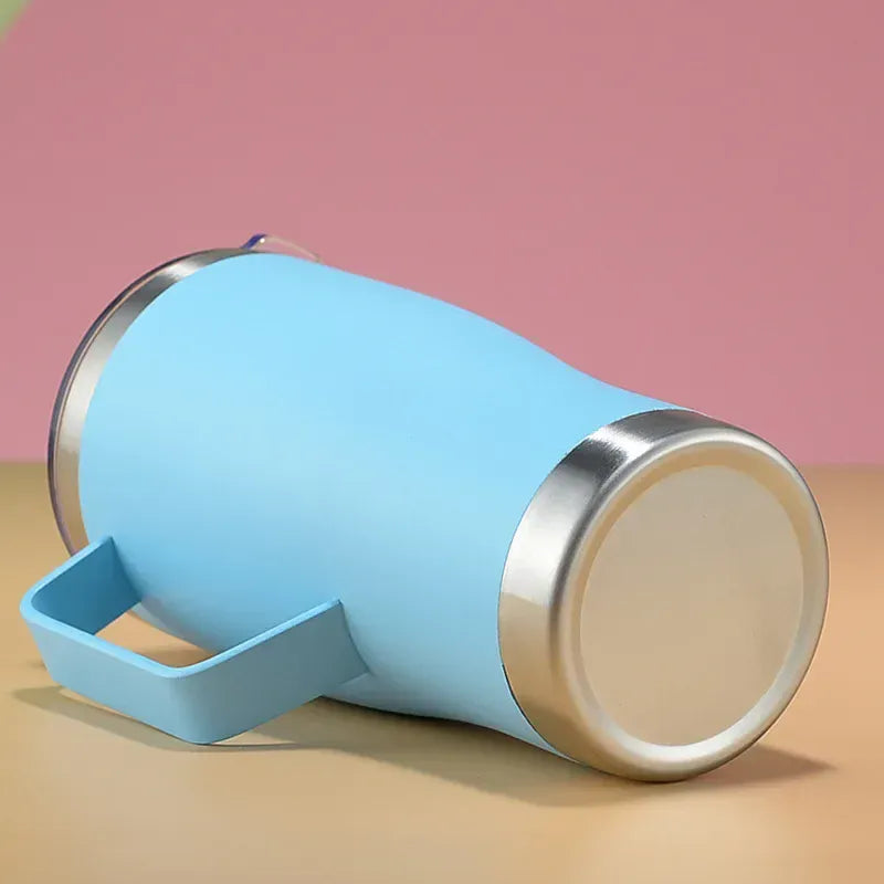 Blue insulated mug with a silver rim on a pink and beige background