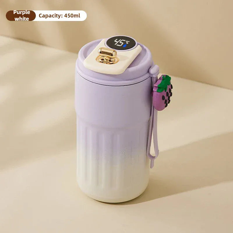 Purple and white thermos with digital temperature display on a beige background