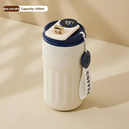 White mug with blue lid and handle on a beige background