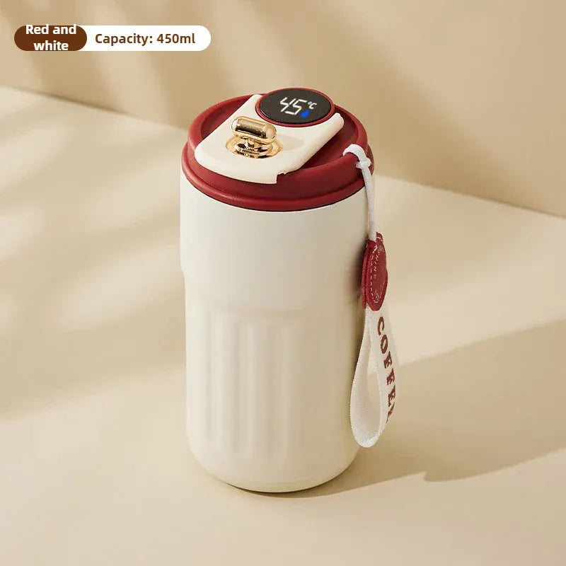 White mug with red lid and handle on a beige background