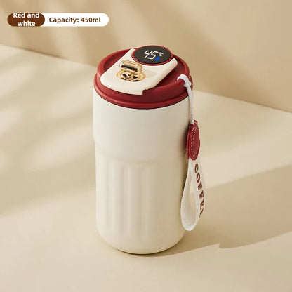 White mug with red lid and handle on a beige background