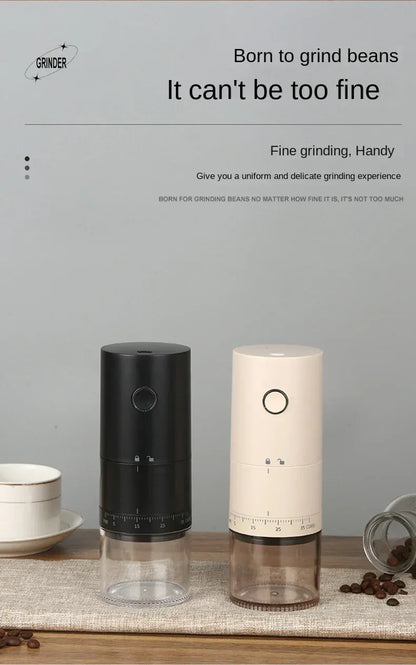 Two coffee grinders, one black and one white, on a wooden surface with a gray background.