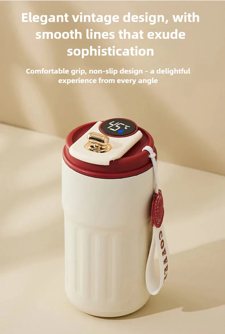 White mug with red lid and handle on a beige background, featuring text about its design and comfort.