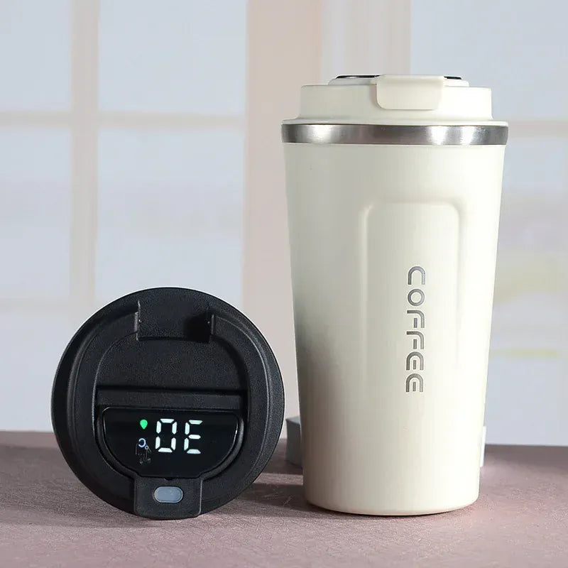 White insulated coffee tumbler with digital temperature display on a neutral background