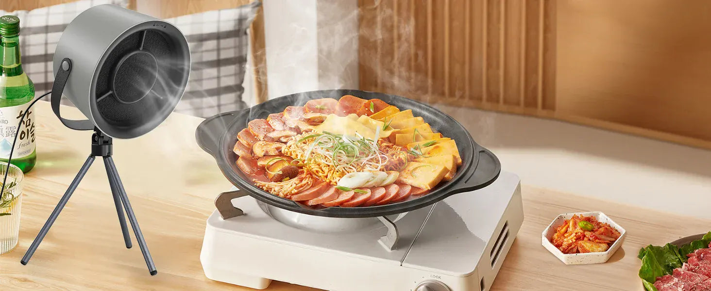 Hot pot meal on a portable stove with a small lamp in a kitchen setting
