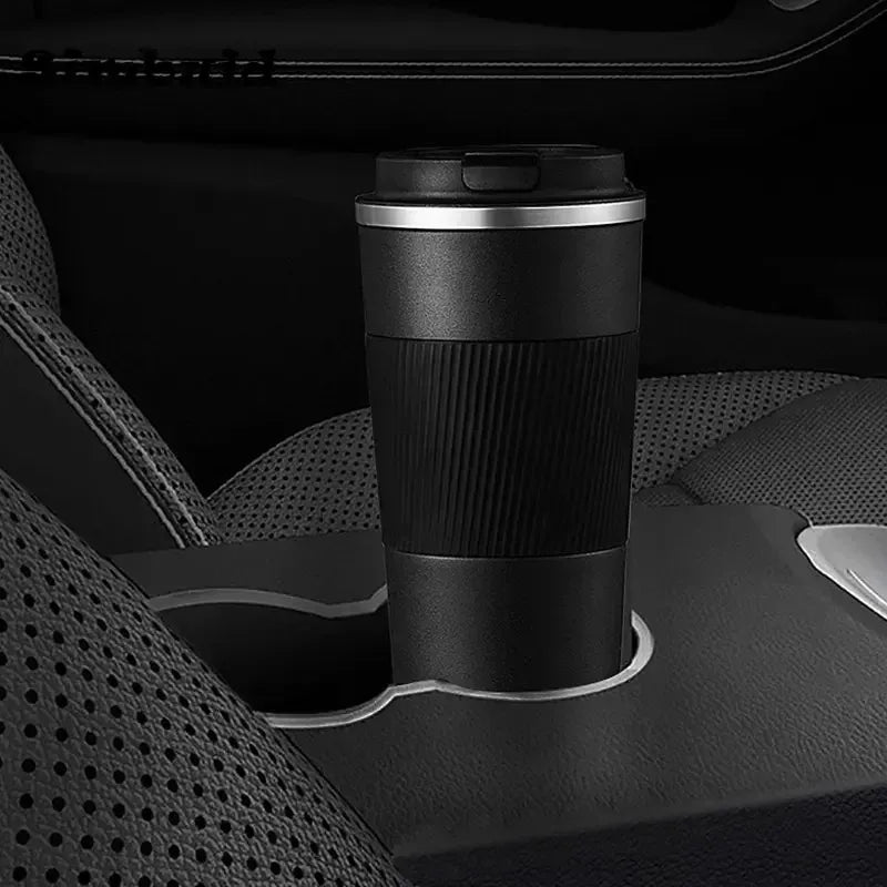 Black insulated travel mug on a car cup holder