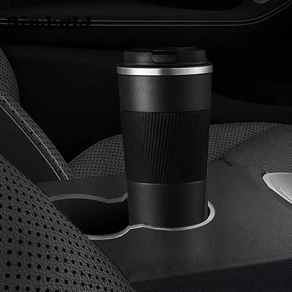 Black insulated travel mug on a car cup holder
