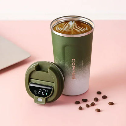 Green insulated coffee tumbler with digital temperature display on a pink background