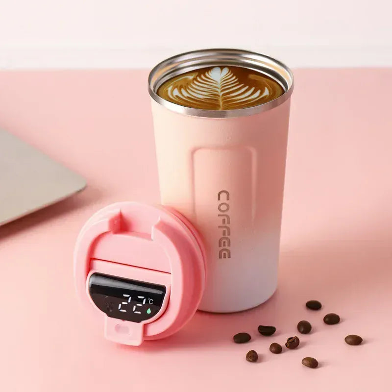 Pink coffee tumbler with digital temperature display on a pink background