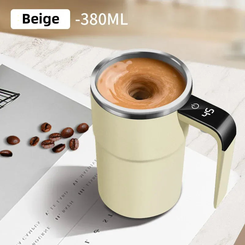 Beige travel mug with coffee, coffee beans, and a laptop on a light surface