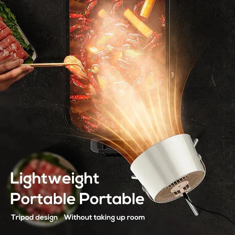 Portable hot pot with food being cooked, featuring a tripod design on a dark background.