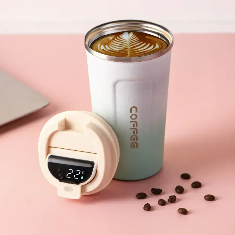 Coffee tumbler with a digital thermometer on a pink background