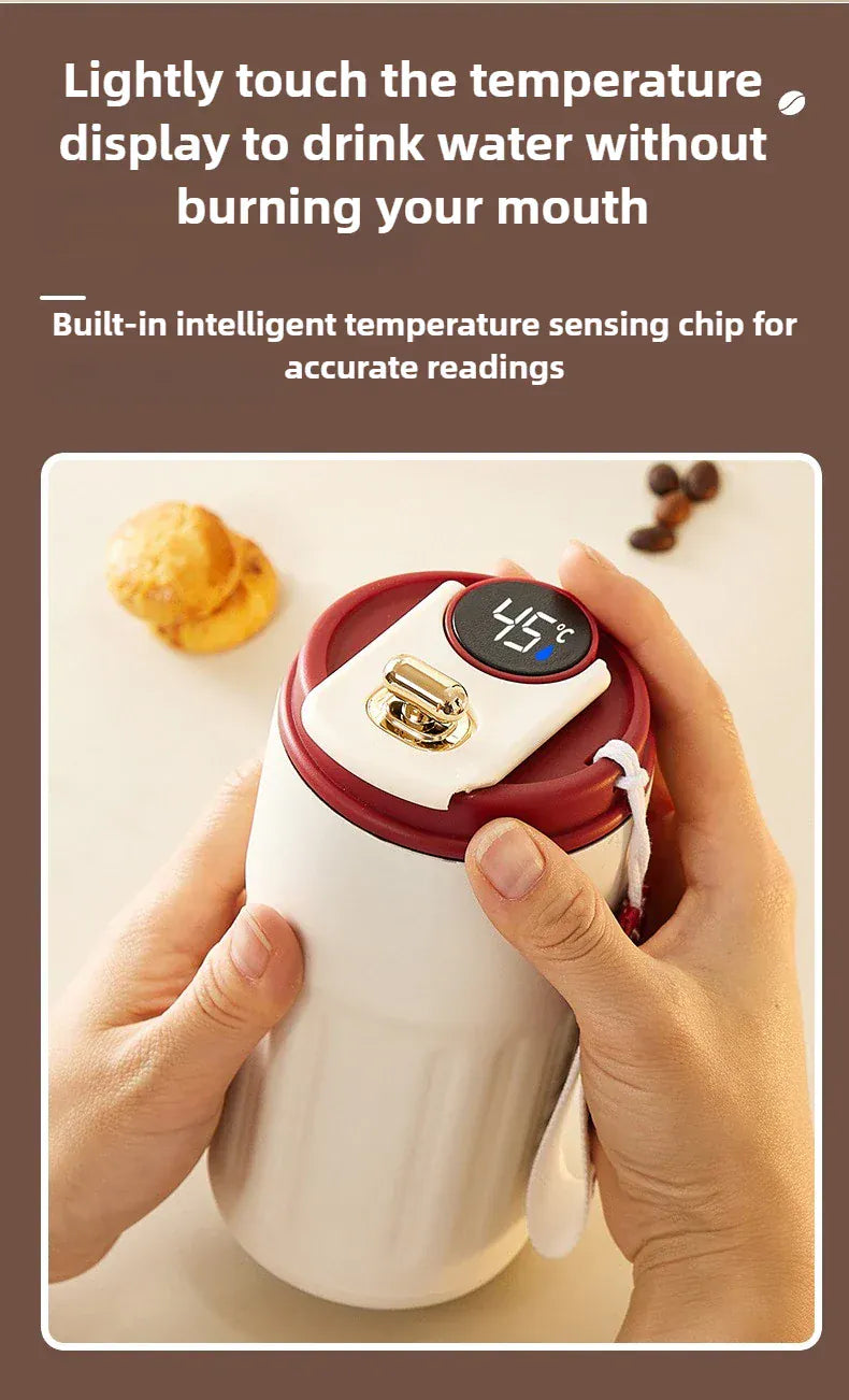 White mug with red lid displaying temperature, held by a hand, with text about temperature sensing.