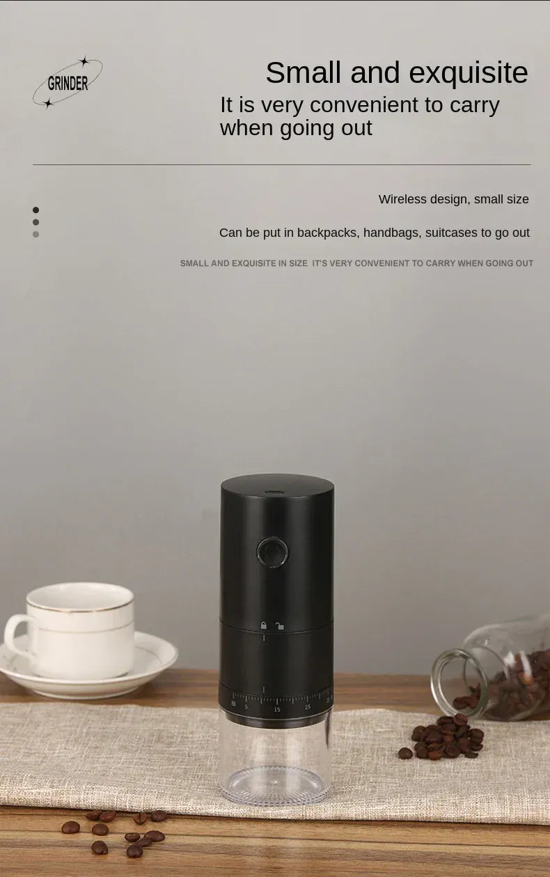 Black coffee grinder on a wooden surface with coffee beans and a cup, against a gray background.