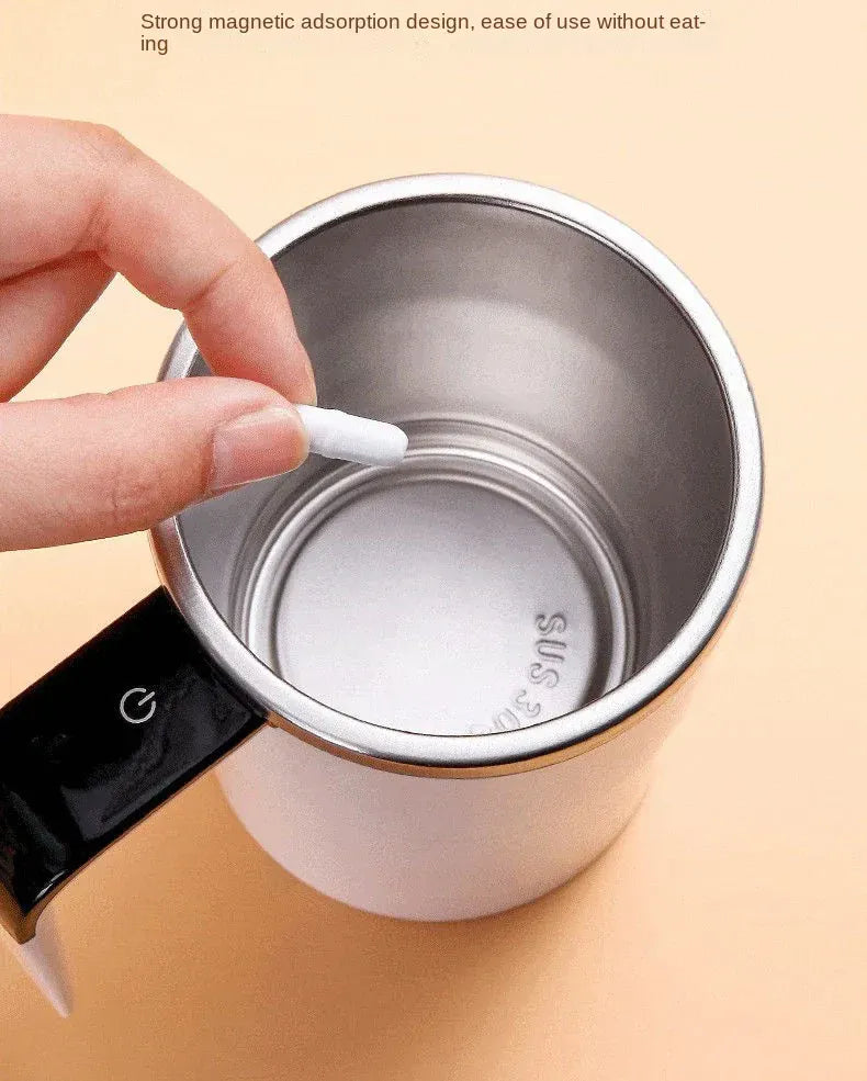 Hand holding a white cotton swab over a silver container with a black lid on a beige background.