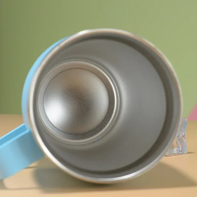 Close-up of a blue and silver container on a wooden surface with a green background