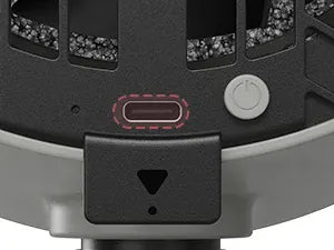 Close-up of a device with a power button and other controls on a gray background