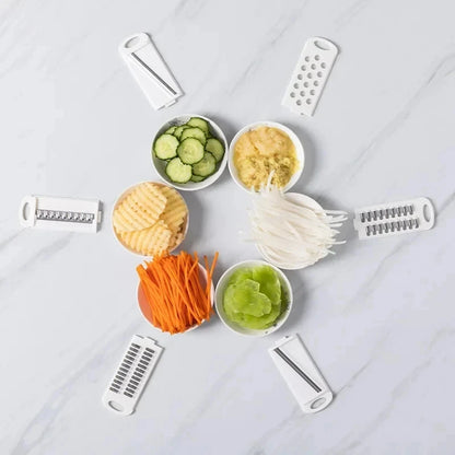 Set of vegetable peelers with sliced vegetables on a light gray background