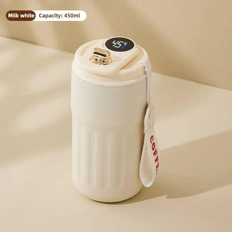 White thermos with digital temperature display on a beige background