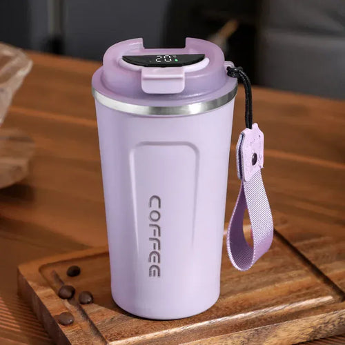 Purple coffee tumbler with digital temperature display on a wooden surface