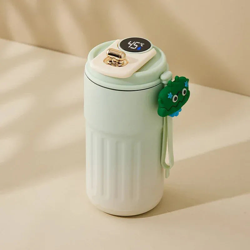 Light green mug with a temperature display and a green handle on a beige background